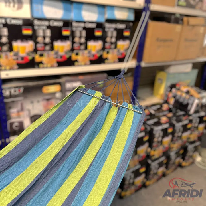 A striped fabric hammock in blue, light blue, and lime green.