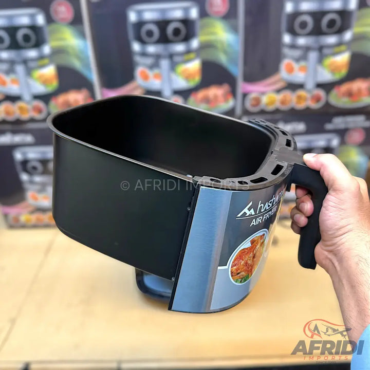 Black air fryer basket with a handle.