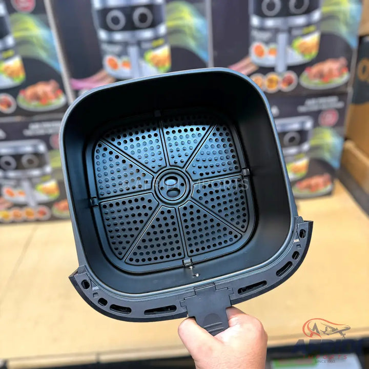 Black air fryer basket with a perforated bottom and a handle.
