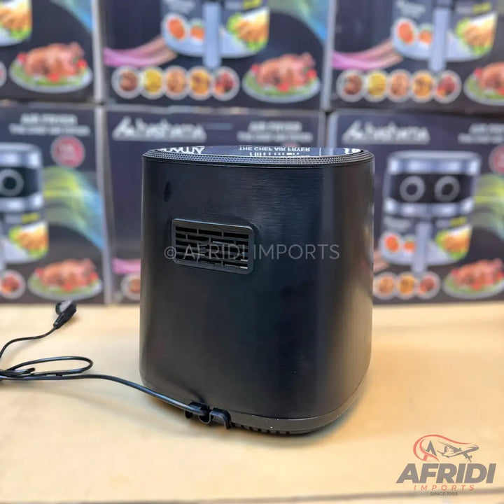 Black compact air fryer with a vent on the back and a visible power cord.