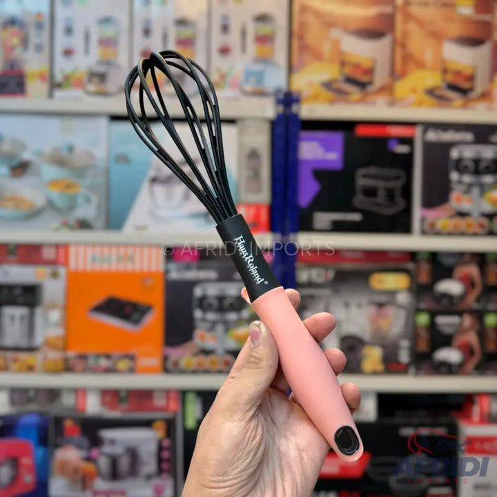 Pink-handled black whisk.