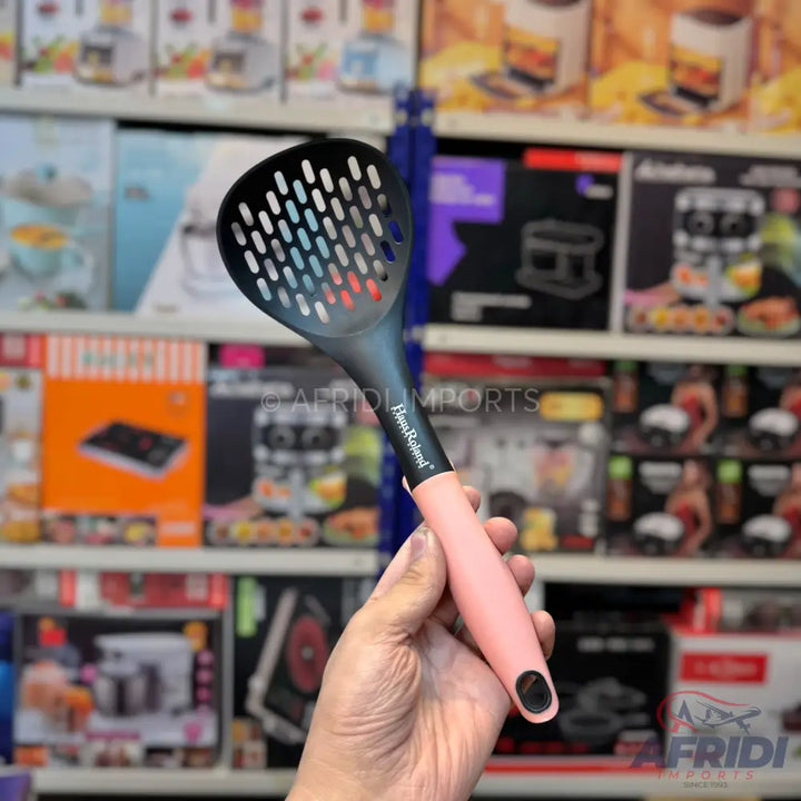 Black slotted spoon with a pink handle.