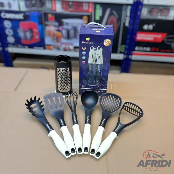 A set of black and white kitchen utensils with a grater and a storage box.