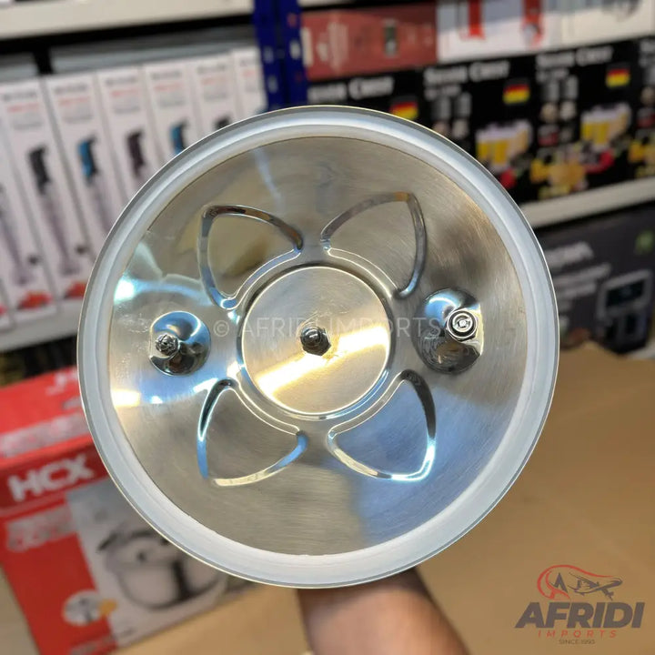A stainless steel food processor blade assembly with four curved blades and a central drive shaft.