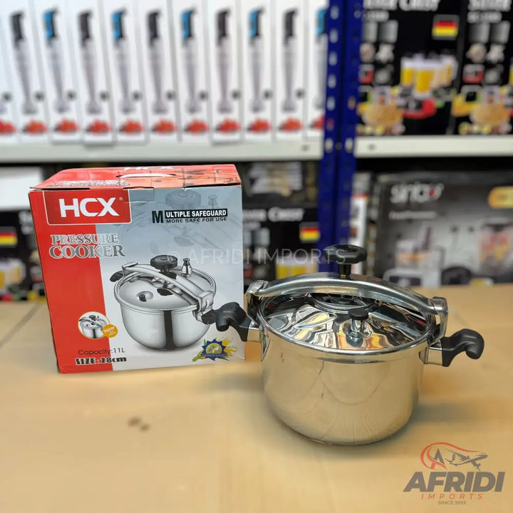 A stainless steel pressure cooker with a black handle and lid.