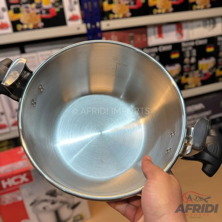 Stainless steel cooking pot with riveted handles and internal measurement markings.