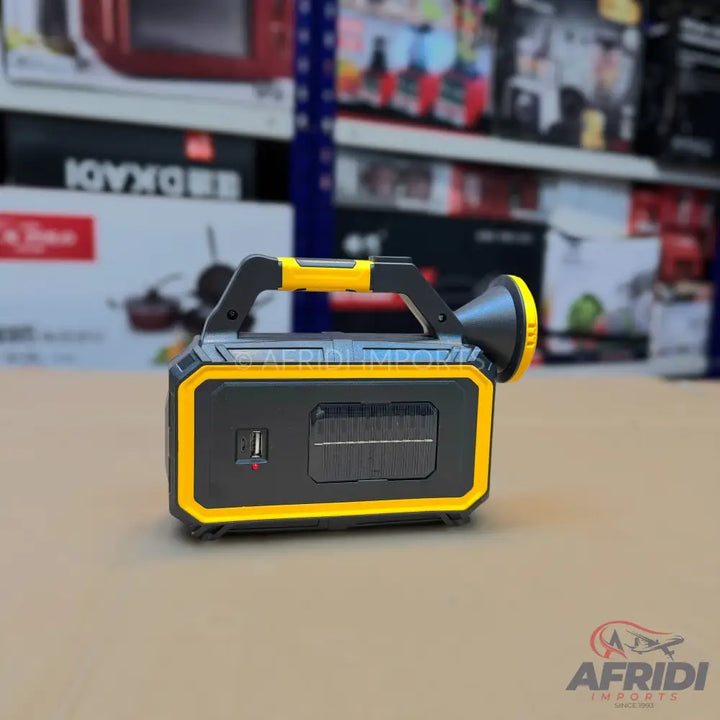 Black and yellow portable power station with a built-in flashlight, USB port, and solar panel.