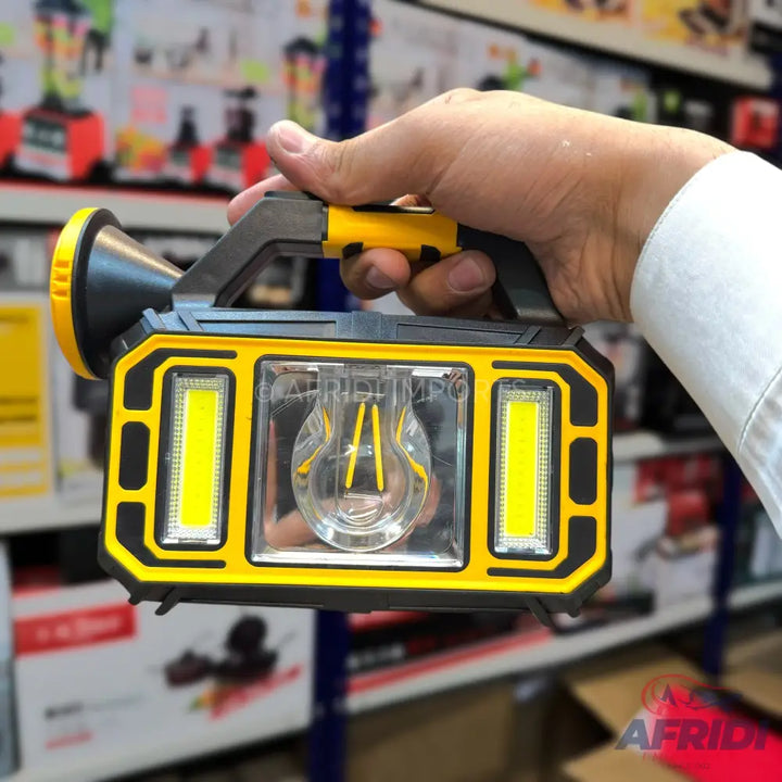 Handheld yellow and black multi-function LED lantern with a spotlight and side panel lights.