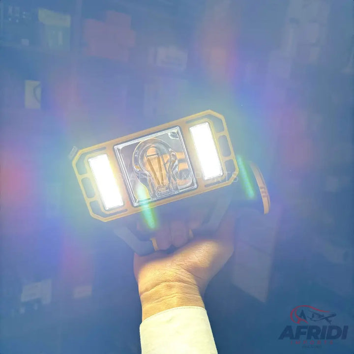 A handheld yellow and black portable work light with two bright LED panels and a central decorative element.