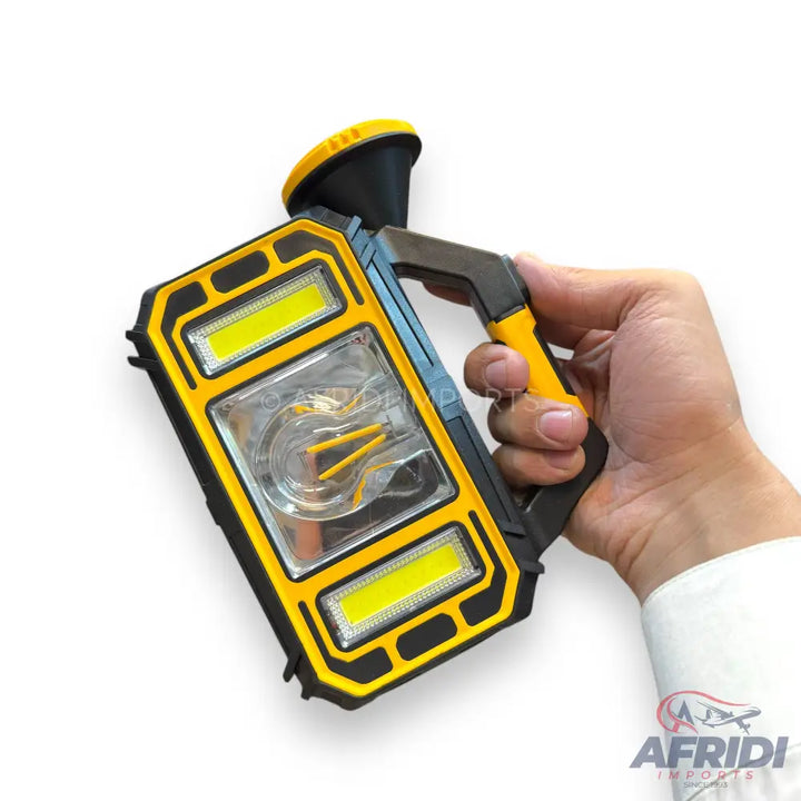 A yellow and black multi-function work light with a top-mounted spotlight, two rectangular side COB lights, and a central transparent section revealing three internal yellow elements.