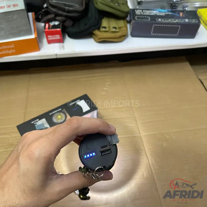 Compact black power bank with multiple USB ports and a battery level indicator.