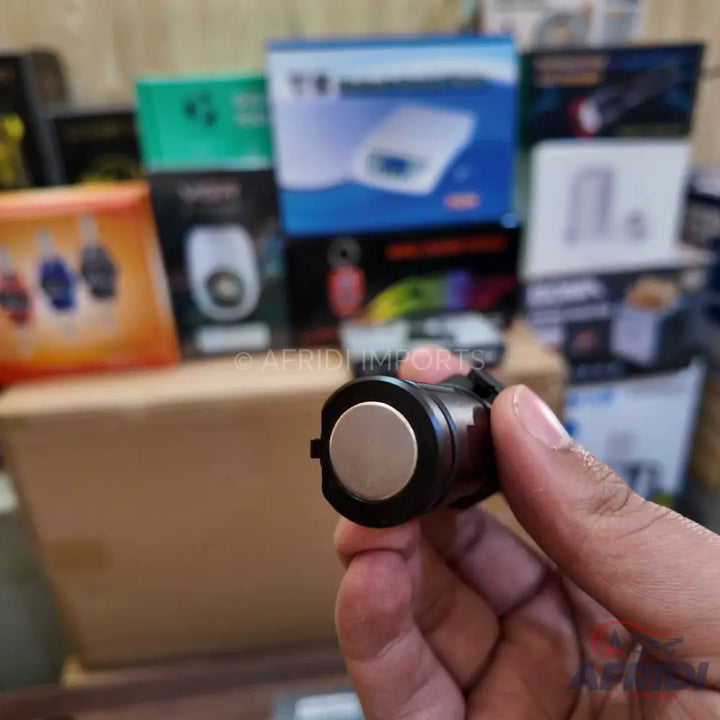 Black and silver ultrasonic parking sensor.