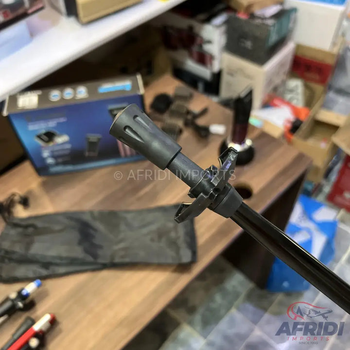 A black metal tripod with a multi-pronged head.