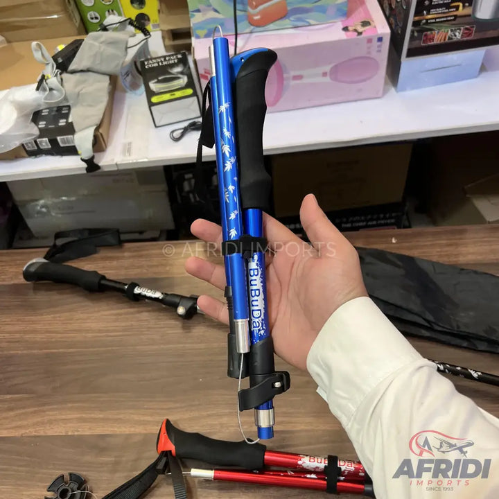 Foldable blue trekking pole with a black handle.