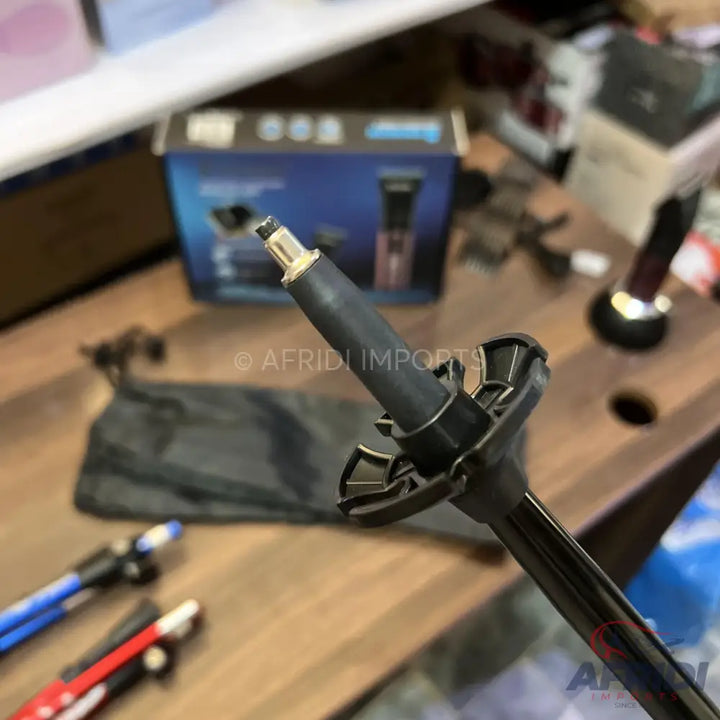 Black trekking pole with a snow basket and a metallic tip.