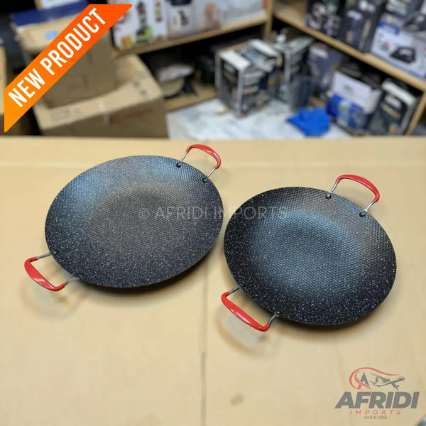 Two round, black, speckled non-stick cooking pans with red handles.
