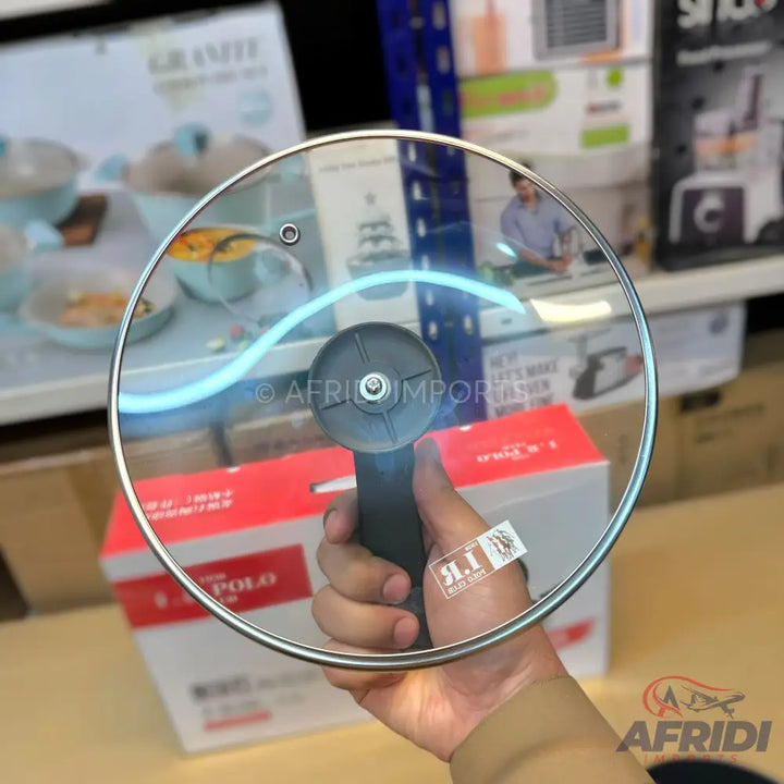 Glass pot lid with a black handle.