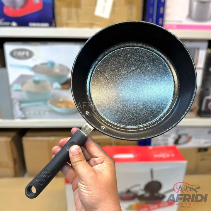Black non-stick frying pan with a textured handle.