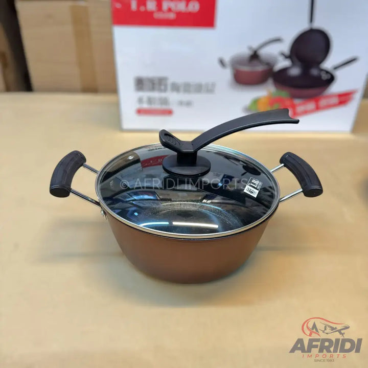 Brown non-stick cooking pot with a glass lid and black handles.