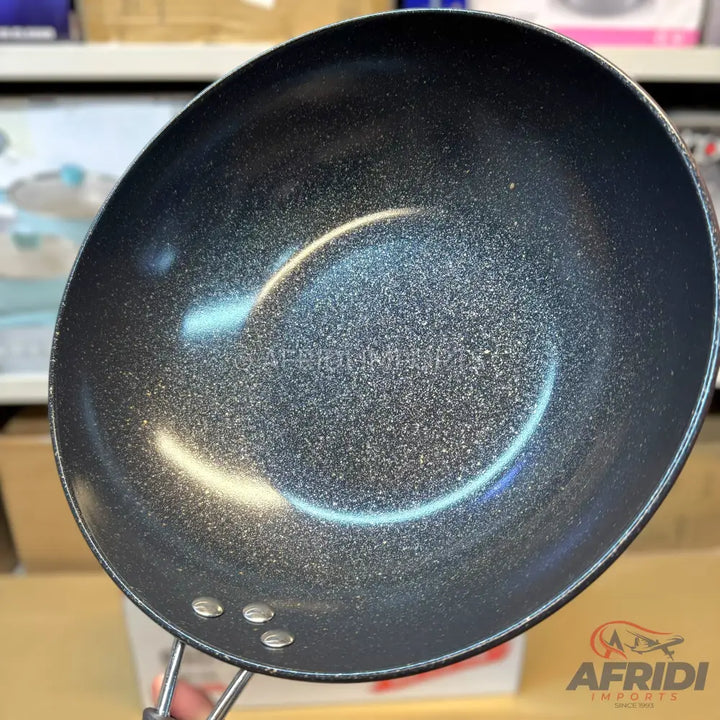 A black, non-stick, speckled frying pan with a single handle.