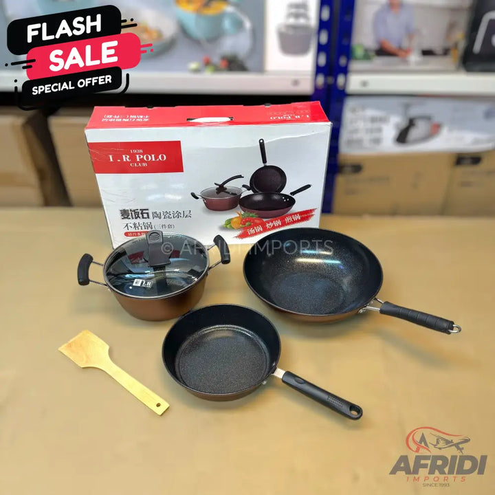 A three-piece non-stick cookware set including a wok, a frying pan, and a pot with a glass lid, along with a wooden spatula.