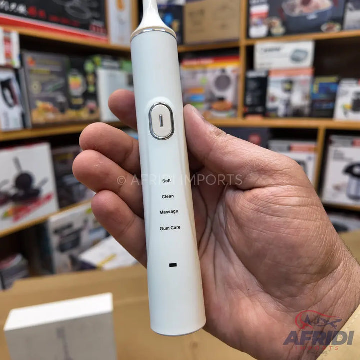 White electric toothbrush with multiple cleaning modes.