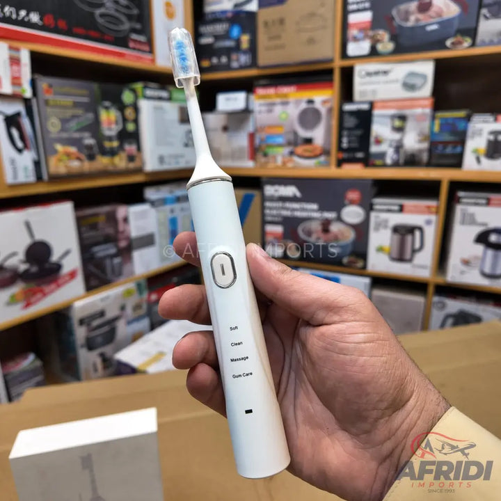 White electric toothbrush with multiple cleaning modes.