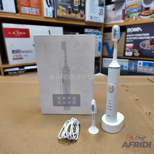 White electric toothbrush set with charging base, replacement head, and USB cable.