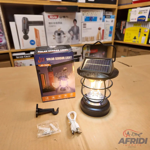 Black solar-powered lantern with an exposed filament bulb.
