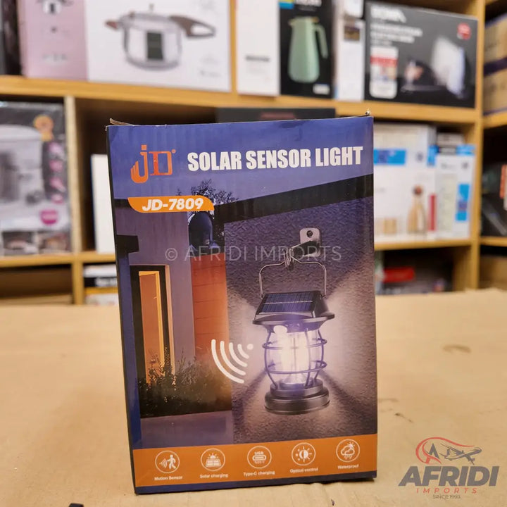Box for a JD-7809 solar sensor light, featuring images of two light styles and icons depicting its functions.