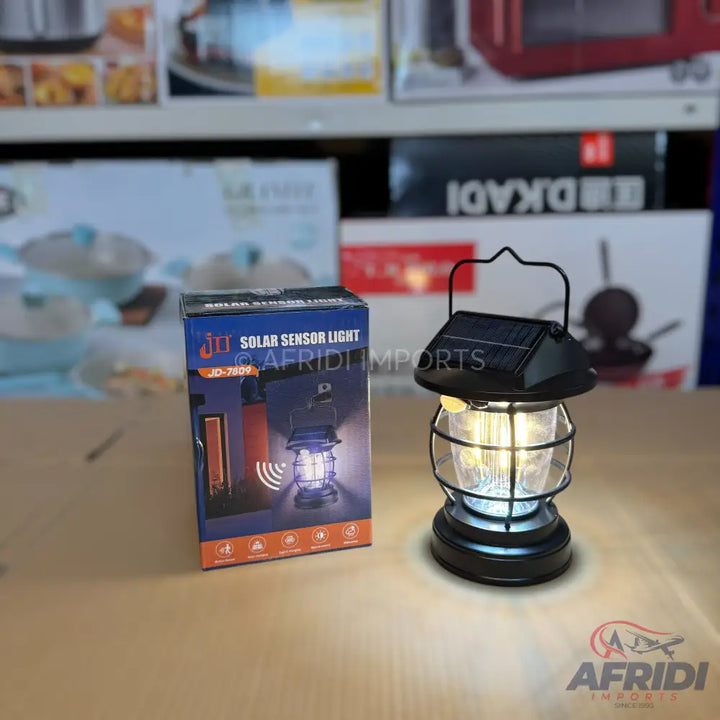 Black solar-powered lantern with a caged design.