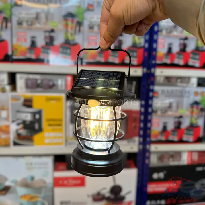 Hand-held solar-powered outdoor lantern with a classic, caged design.
