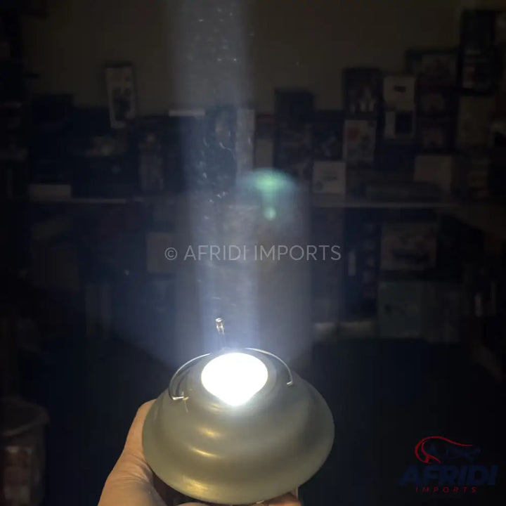 A handheld, bright white LED flashlight with a reflective, bowl-shaped casing.