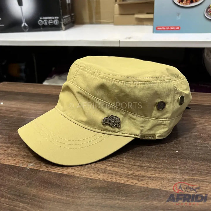 Khaki green military-style cap with a metal Jeep emblem and two decorative metal eyelets on the side.