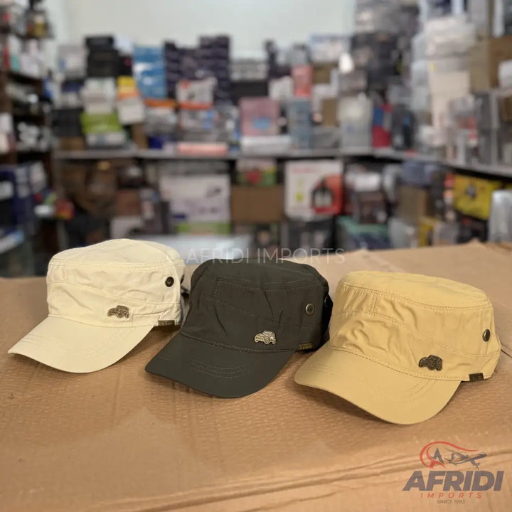 Three military-style caps in beige, dark green, and tan.