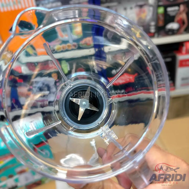 Clear plastic blender jar with a four-pronged blade.