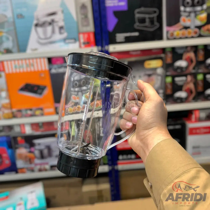 Clear plastic blender pitcher with a black lid and base, and an integrated blade assembly.