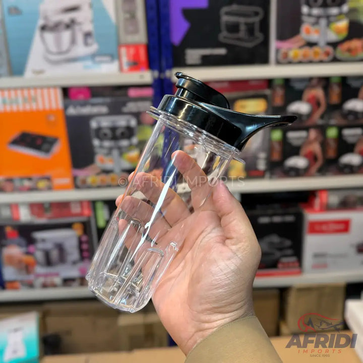 Clear plastic blender cup with a black lid and pouring spout.