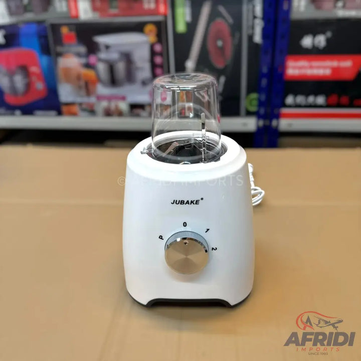 A white electric blender with a clear mixing cup and a silver control knob.