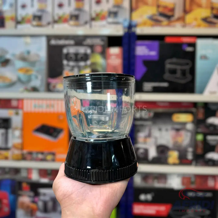 Clear glass blender cup with a black base.