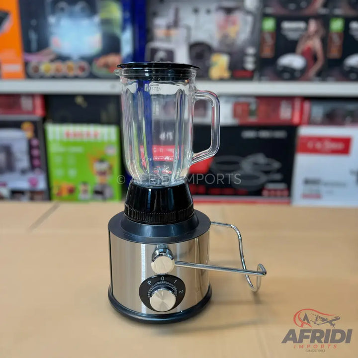 A stainless steel blender with a glass jar and a black base, featuring a speed dial and a handle for easy pouring.