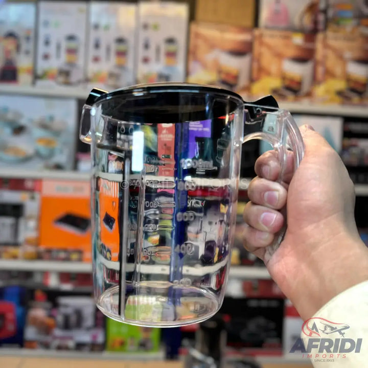 Clear plastic measuring cup with a black lid and handle.