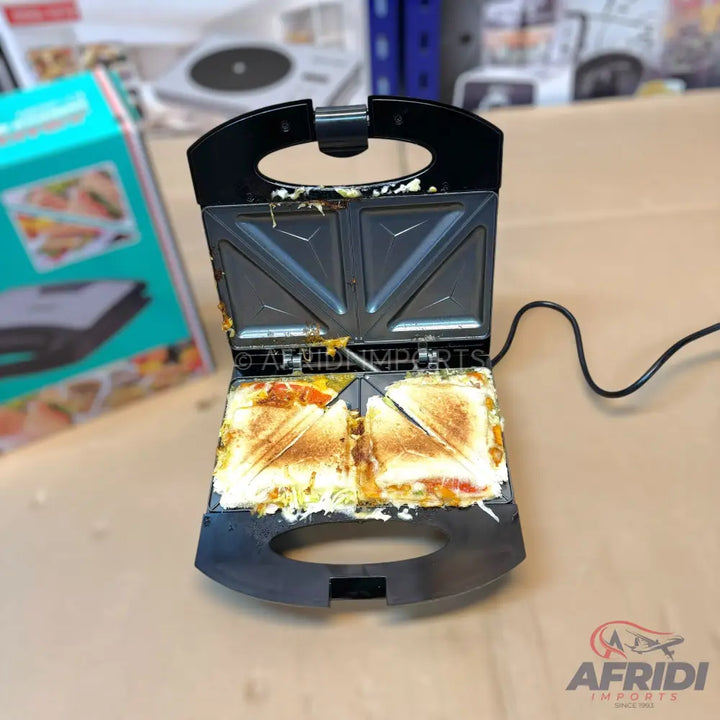 An open black sandwich maker with two toasted sandwiches inside, featuring a non-stick cooking surface.