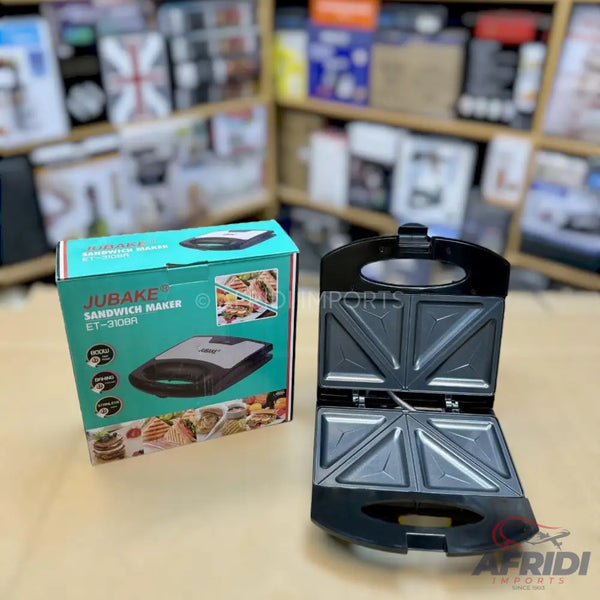 A black and silver sandwich maker, open to show its triangular heating plates, with its product box displaying features and food images.