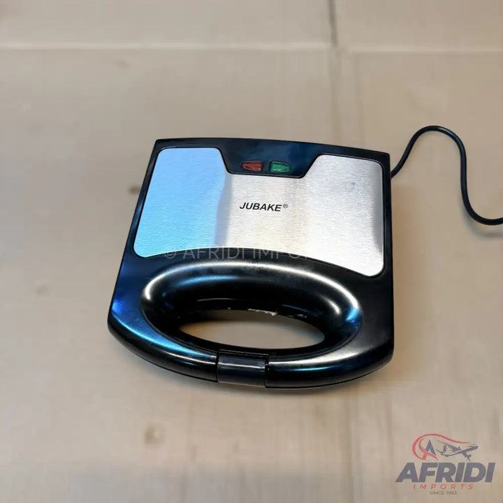 Black and silver electric sandwich maker with two indicator lights.