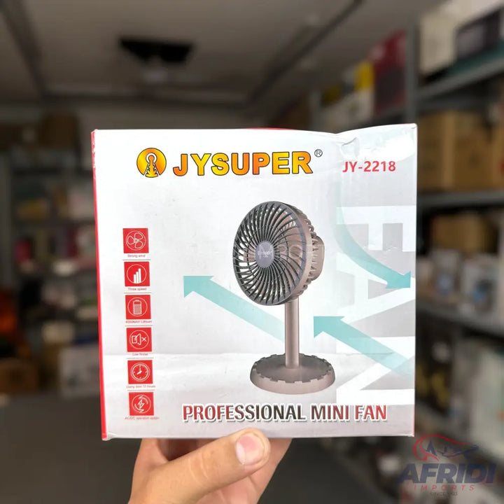 A packaged JYSUPER JY-2218 professional mini fan with features like strong wind, long battery life, low noise, and strong airflow.