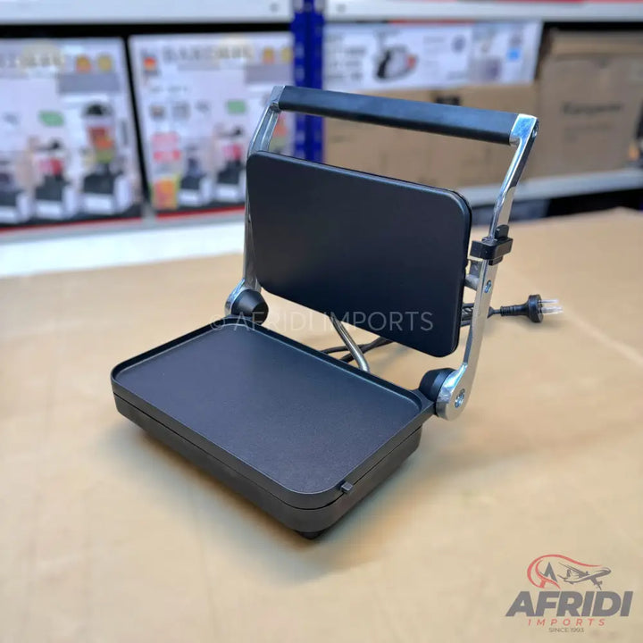A black electric grill or panini press with a non-stick cooking surface.