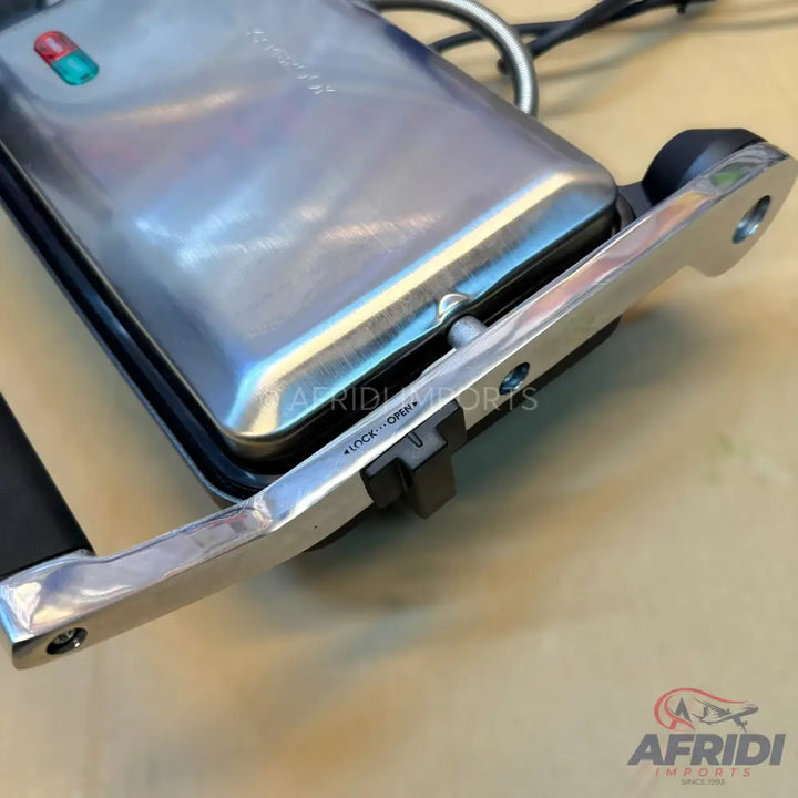 A closed stainless steel sandwich maker with power indicator lights and a locking mechanism.