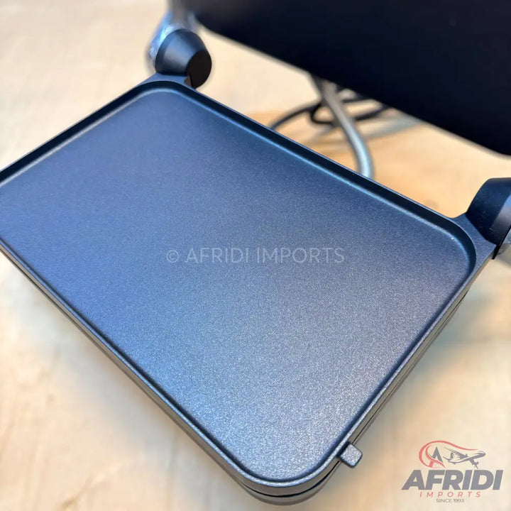 Black non-stick griddle plate with a shallow rim.