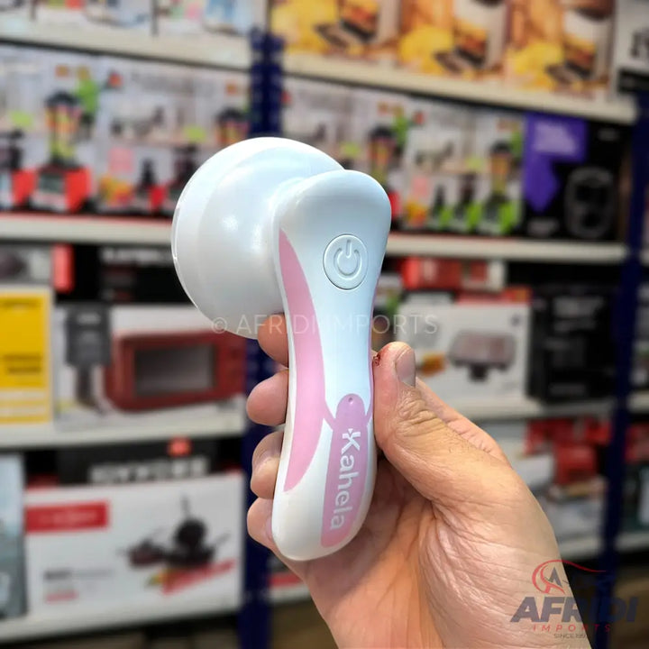 White and pink handheld electric facial cleansing brush with a power button.
